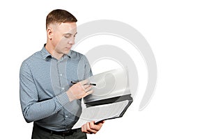 Portrait of handsome young guy holding folder and pen. Isolated on white background