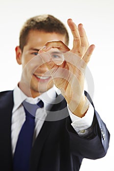 Portrait of handsome young man gesturing okay sign