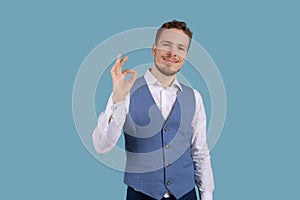 Portrait handsome young man makes normal gesture, shows consent, loves idea