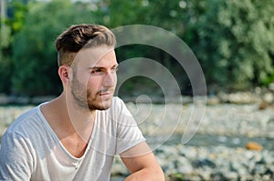 Portrait of handsome young man outdoors in nature