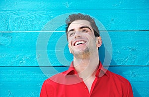 Portrait of a handsome young man smiling outdoors