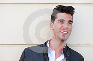 Portrait of a handsome young man smiling outdoors