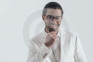 portrait of handsome young man touching chin and smiling