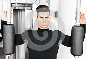 Portrait of a handsome young man training in a gym