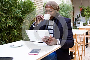 Handsome young man using his digital tablet in the cafe.
