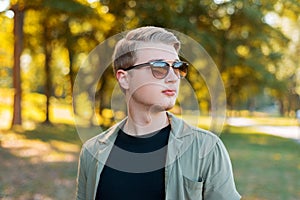 Portrait of handsome young stylish man with sunglasses standiing outdoor