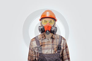 Portrait of handyman in protective work equipment against grey background.