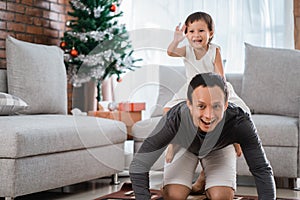 Portrait of happiness little daughter sitting on father back and