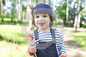 Portrait of happy 2 years boy with lolly