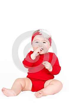 Portrait of a happy adorable Infant child baby girl lin red sitting happy smiling on a white background