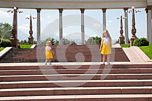 Portrait of happy adorable two sisters children girls outdoor. Cute little kid in summer day