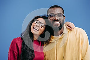 portrait of happy african american couple in eyeglasses looking at camera
