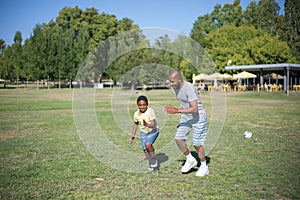 Portrait of happy African American dad and his son playing