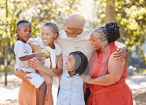 Portrait happy african american family of five spending quality time together in the park during summer. Grandparents