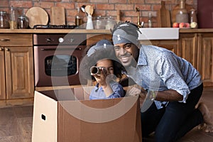Portrait happy African American family playing pirates at home together