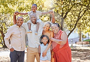 Portrait happy african american family of six spending quality time together in the park during summer. Grandparents