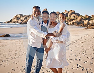 Portrait of a happy african american family with two children standing together on the beach. Loving mother and father