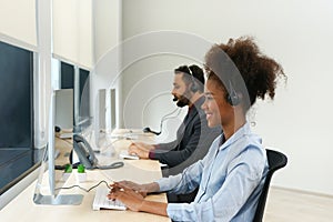 portrait happy african american female wear headsets is working in a call centre