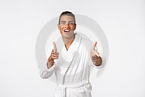 Portrait of happy African American handsome man laughing and showing thumb up gesture.