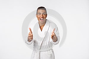 Portrait of happy African American handsome man laughing and showing thumb up gesture.