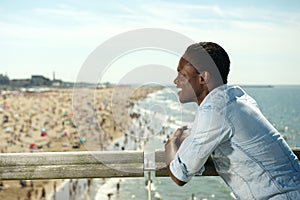 Portrait of a happy african american man smiling at the beach