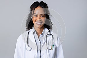 Portrait of happy african american mid adult female doctor with stethoscope against white background