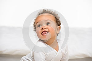 portrait of happy african american toddler boy looking away