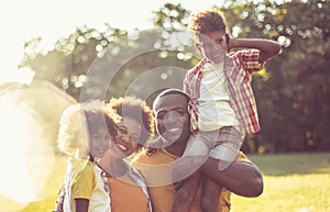 Portrait of happy African family. In the park