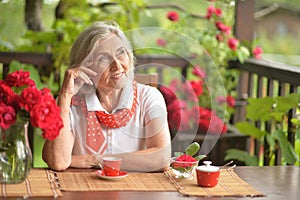 Portrait of a happy aged woman drinking coffee