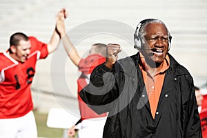 Portrait of Happy american football coach celebrating goal