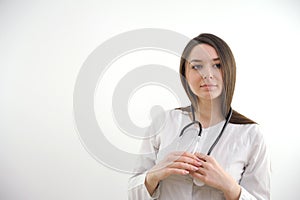 Portrait of happy american mid adult woman with stethoscope and hands in pockets, copy space. white background