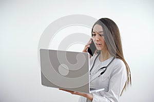 Portrait of happy american mid adult woman with stethoscope and hands in pockets, copy space. white background