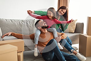 Portrait of happy Arab family having fun on moving day