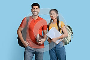 Portrait of happy arab student couple with backpacks and books