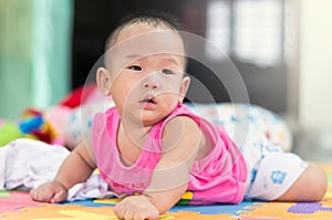 Portrait of happy asian baby on the bed