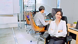 Portrait of happy Asian businesswoman arms crossed and smile in startup company office, business coworker working on computer