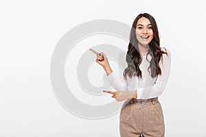 Portrait of a happy asian businesswoman pointing finger away