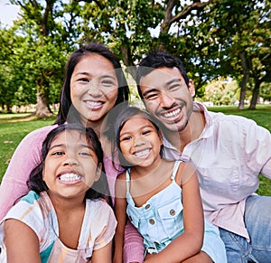 Portrait of happy asian family in the park. Family portrait of husband and wife sitting and enjoying free time with