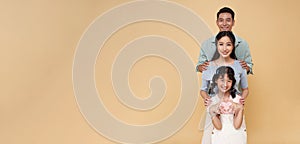 portrait happy asian family standing together isolated on color copy space background