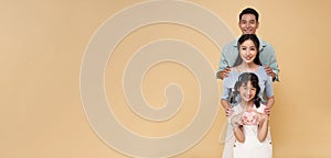 portrait happy asian family standing together isolated on color copy space background