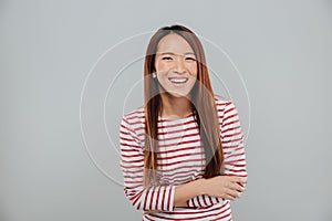 Portrait of a happy asian girl laughing while standing