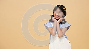 Portrait of happy Asian kid child girl thinking idea and looking up to copy space isolated on color background