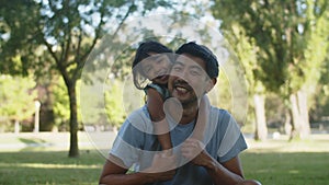 Portrait of happy Asian man sitting with his little daughter