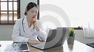 Portrait happy asian woman doctor, Telemedicine concept. Asian female doctor talking with patient using laptop online video