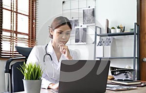 Portrait happy asian woman doctor, Telemedicine concept. Asian female doctor talking with patient using laptop online video