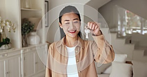Portrait of happy Asian woman holding bunch of keys