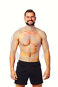 Portrait of a happy athletic man with muscular torso standing