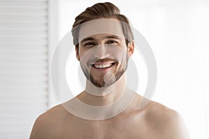 Portrait of happy attractive bearded well built man with stubble