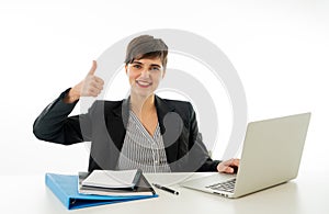 Portrait of happy attractive young businesswoman on laptop looking confident with thumb up