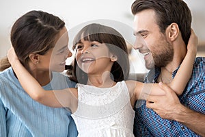 Portrait happy attractive young family posing embracing